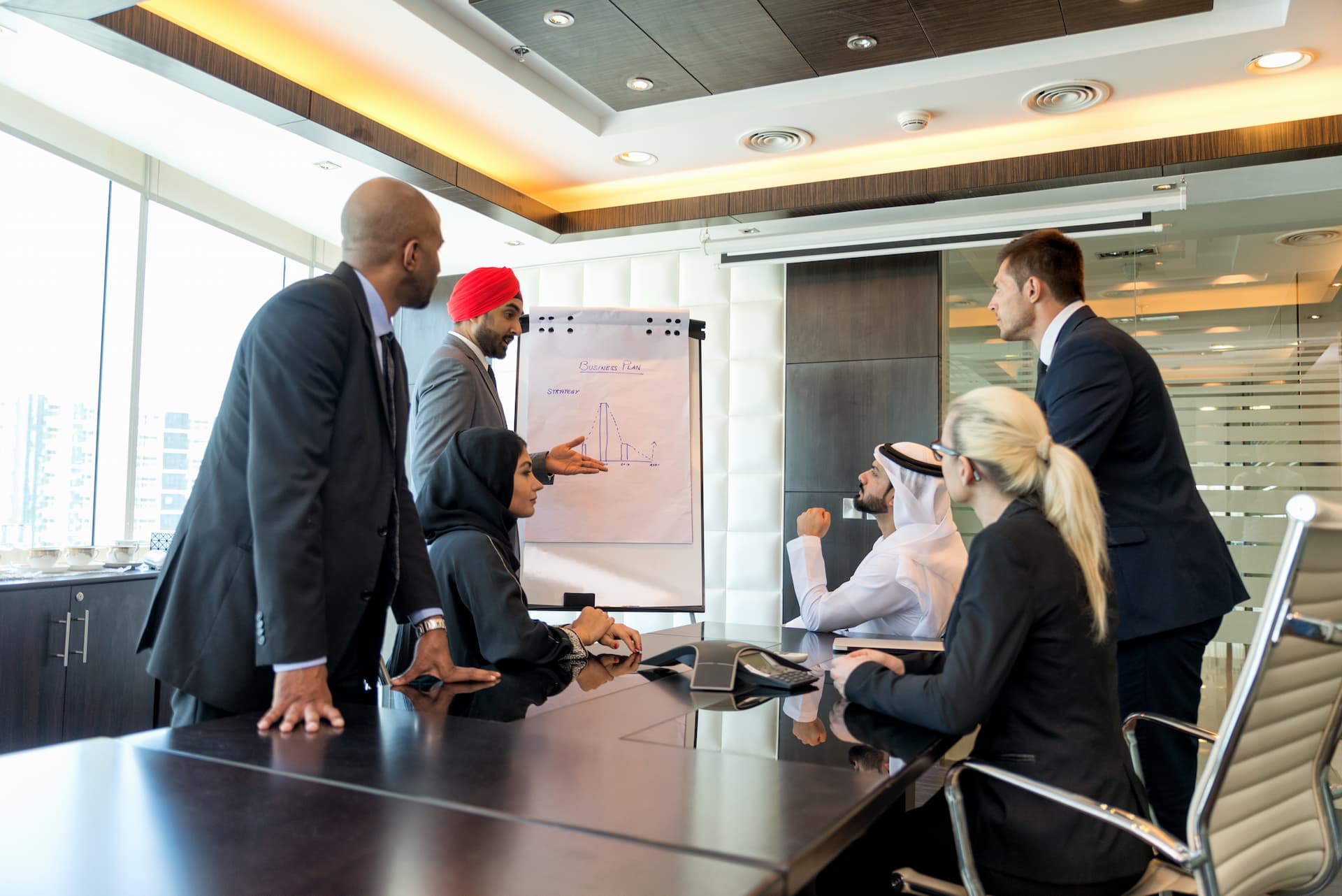 Business leaders discussing plans around a table in an office